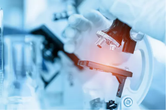 close-up-scientist-using-microscope-laboratory-room-while-making-medical-testing-research