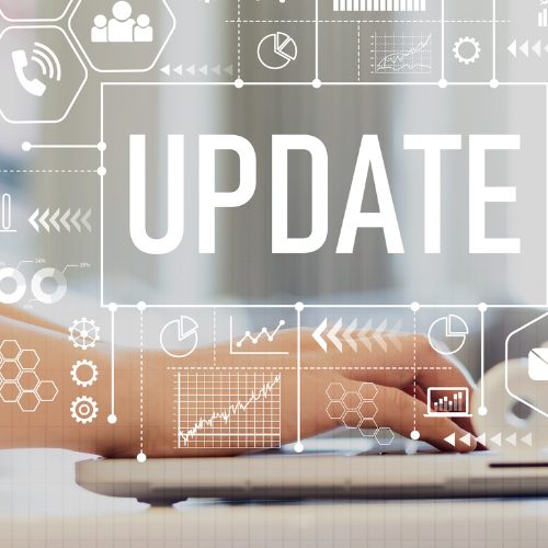 Person typing on a laptop computer with the words "Update" in the background.